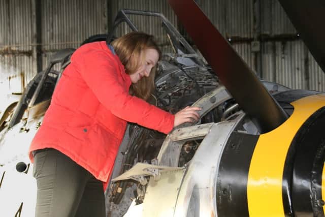 Aeronautical engineer Anne McIlveen checks out some of the
work she did on a vintage Fairey Gannet anti-submarine aircraft of the Royal Navy.
