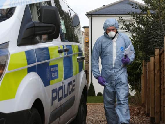 Forensic officers at a house in South Road, Twickenham, south west London, where a murder investigation has been launched after a woman was found dead with stab wounds at the house and her husband and two young boys found dead at Birling Gap, near Eastbourne, East Sussex.