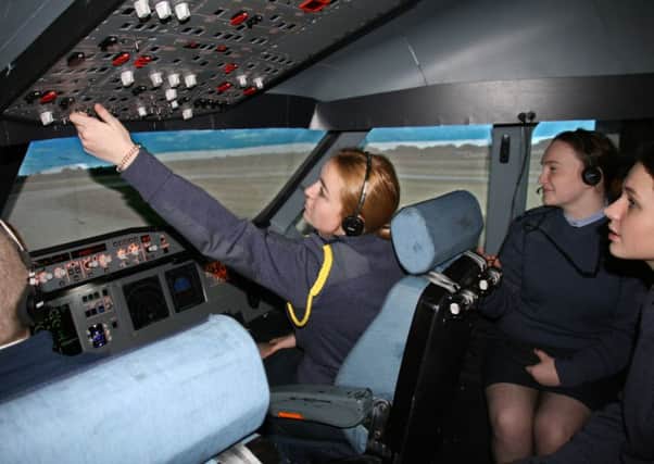 Three air cadets in an Airbus 320 simulator at Ards Airport. Working the controls is Megan Dempster, with Megan Simpson and Madi McCullough (right)