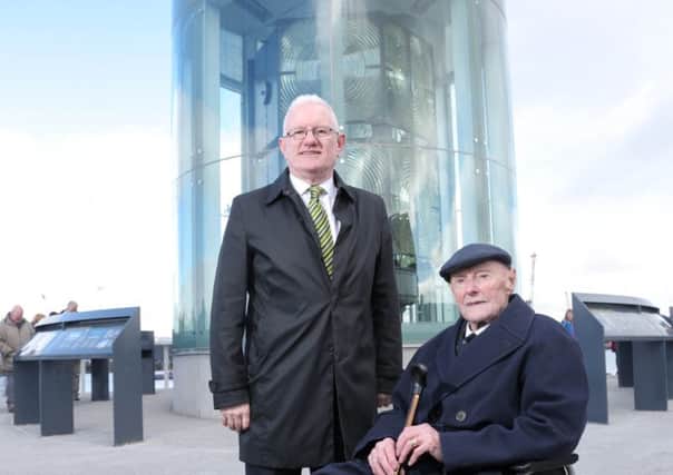 Bill Power and his son Pat view the optic from the lighthouse they once manned at its new location in Belfast's Titanic Quarter