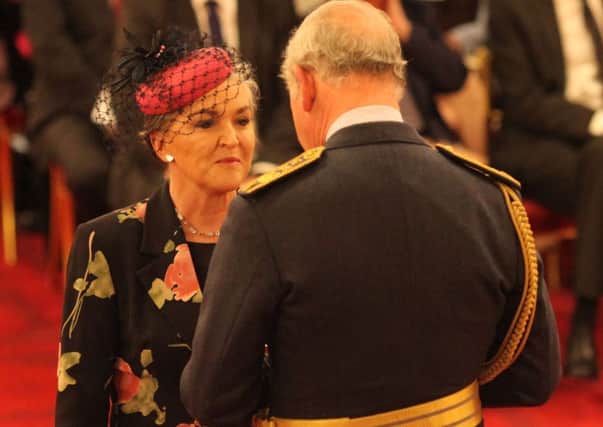 Linda McAuley is made an MBE by the Prince of Wales during an investiture ceremony at Buckingham Palace