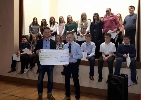 Members of Lylehill YFC making a cheque presentation during their recent parents' night
