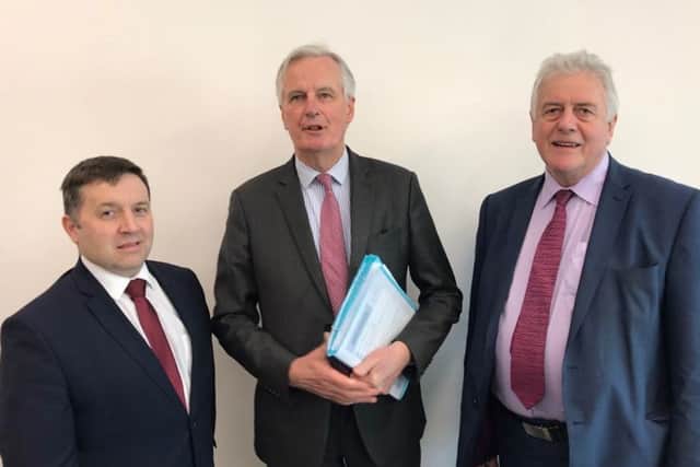 Ulster Unionist leader Robin Swann (left) and Jim Nicholson (right) with Michel Barnier (centre)