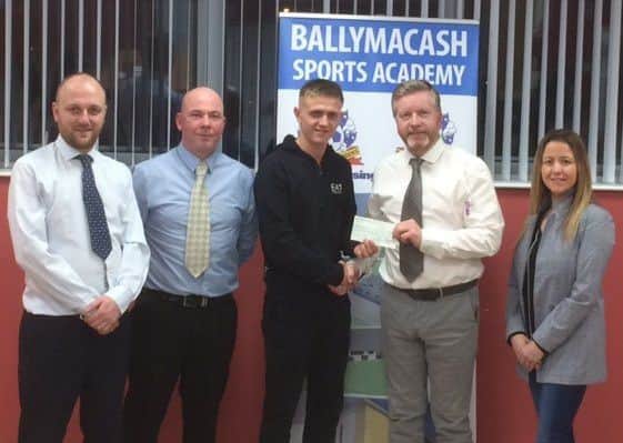 Ballymacash Sports Academy Directors Graham Morris, Clarke Thompson, Kenny McAleenon and Laura Turner present a sponsorship cheque to NI Commonwealth Games boxer Kurt Walker (centre).
