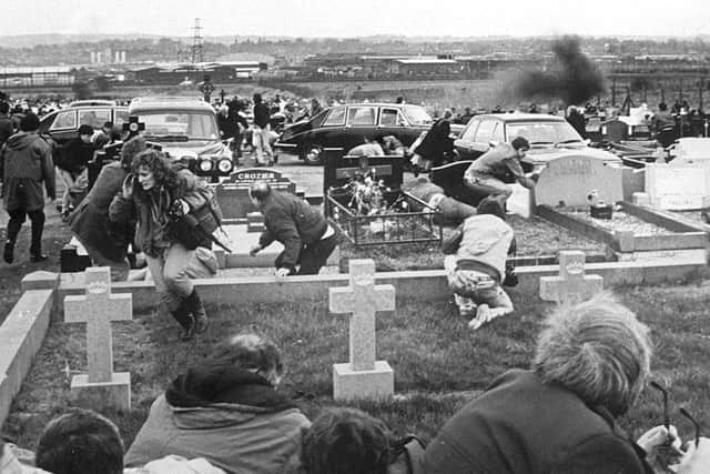 A plume of smoke rises after explosives detonate during loyalist Michael Stone's attack on a republican funeral in 1988