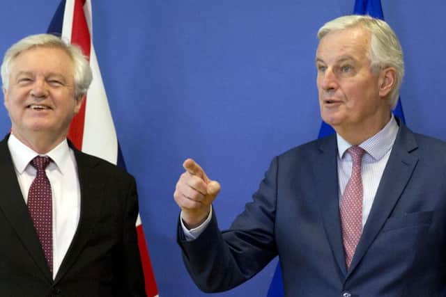 European Union chief Brexit negotiator Michel Barnier, right, gestures as he meets with British Secretary of State for Exiting the European Union David Davis at EU headquarters in Brussels on Monday, March 19