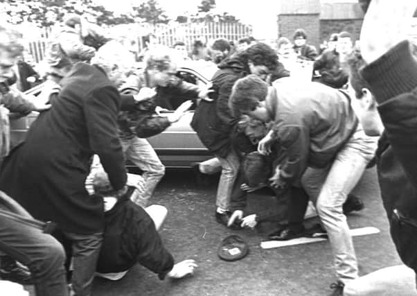 Mourners attacking two Army corporals who had strayed into the path of an IRA funeral in west Belfast in March 1988