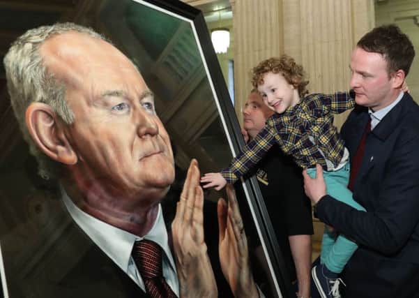 Martin McGuinnes's son Fiachra and grandson Dualta at the unveiling of the portrait of his father, the former deputy first minister