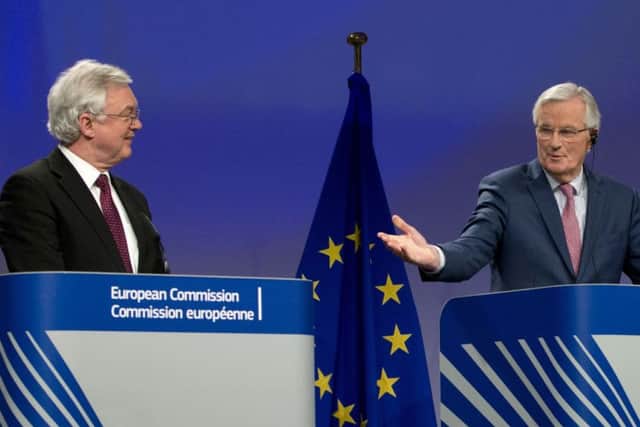 British Secretary of State for Exiting the European Union David Davis, left, and European Union chief Brexit negotiator Michel Barnier, right, participate in a media conference at EU headquarters in Brussels on Monday, March 19, 2018. (Virginia Mayo)