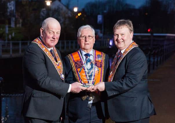 Roy Kells MBE (centre) receives the Lifetime Achievement Award from Grand Master Edward Stevenson (left) and Deputy Grand Master Harold Henning

Orange Community Awards, on the night of 23-03-18