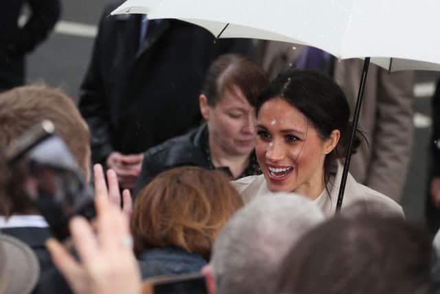 Meghan Markle reacts to wellwishers during a walkabout in Belfast after a visit to the Crown Bar in the city centre.  Photo: Brian Lawless/PA Wire