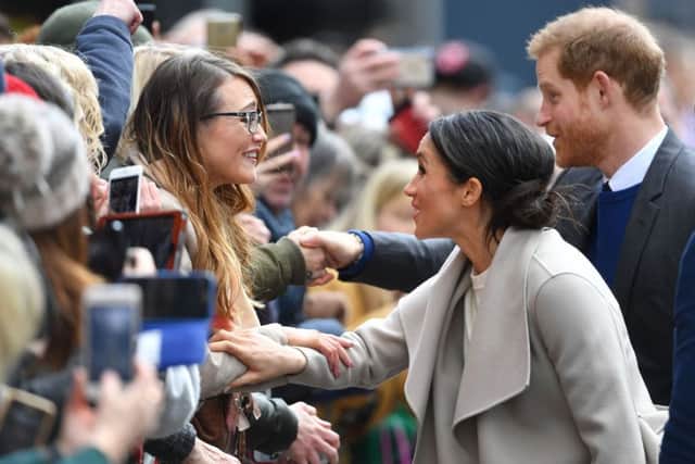 Prince Harry and Meghan Markle meet well-wishers during a walkabout in Belfast