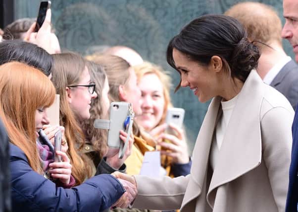 Prince Harry and Meghan Markle meet the crowds after visiting the Crown bar in Belfast