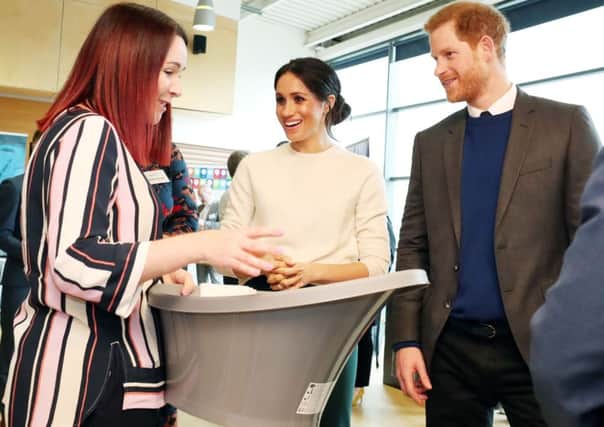 Sinead Murphy from Shnuggle baby products demonstrates a baby bath to Prince Harry and Meghan Markle during a visit to Catalyst Inc science park in Belfast. Photo: Niall Carson/PA Wire