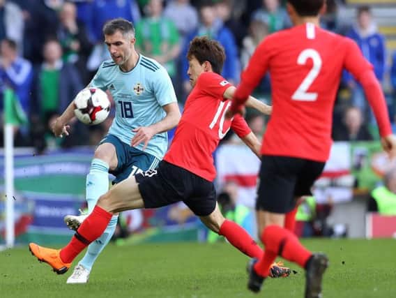 Aaron Hughes in action against South Korea