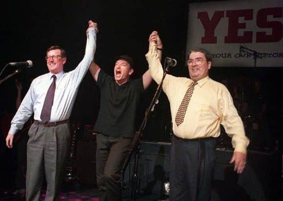 Unionist leader David Trimble, SDLP leader John Hume and Bono of U2 pictured together on stage at the Waterfront Hall in Belfast to promote a Yes vote in the referendum