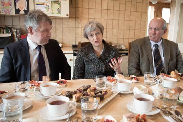 Prime Minister Theresa May having lunch with farmers at Fairview Farm in Bangor, Northern Ireland during a tour of the four nations of the UK, with a promise to keep the country united one year before Brexit.  Stefan Rousseau/PA Wire