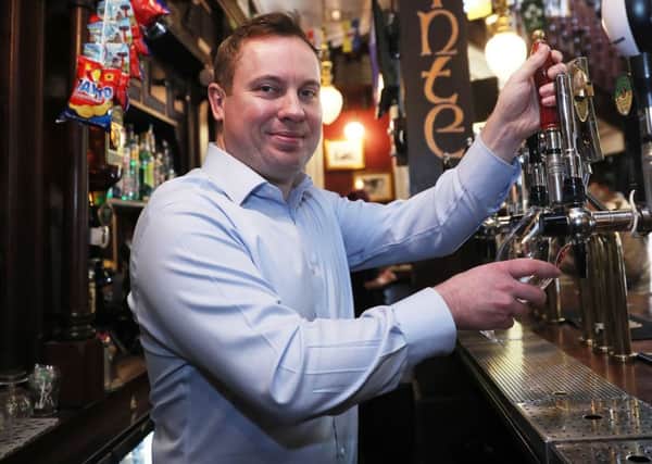 Brian Conlon, owner of Slatterys Bar on Capel street in Dublin, pulls a pint as legislation was passed earlier this year to allow pubs to serve alcohol