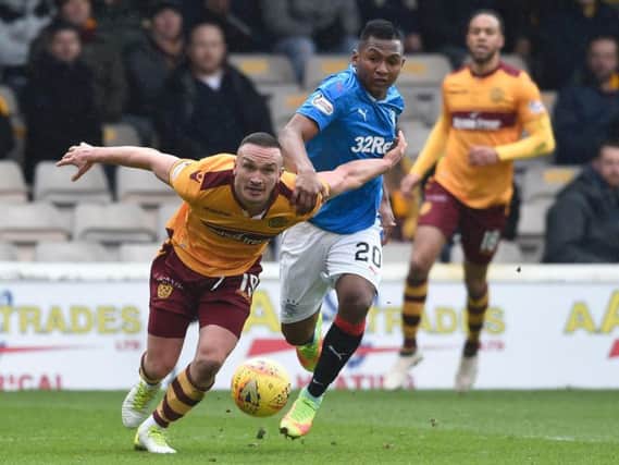 Motherwells Tom Aldred (left) and Rangers Alfredo Morelos battle for the ball during the Scottish Premiership match at Fir Park,