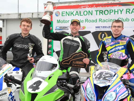 Gerard Kinghan celebrates his Enkalon Trophy success with runner-up Charles Stuart (left) and Luke Johnston at Bishopscourt on Saturday.