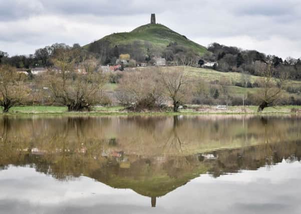 St Michael's Tower on the top of Glastonbury Tor, Somerset, is reflected in floodwater, as forecasters have warned of treacherous driving conditions for Easter holidaymakers with snow and torrential rain on the way. Photo: Ben Birchall/PA Wire