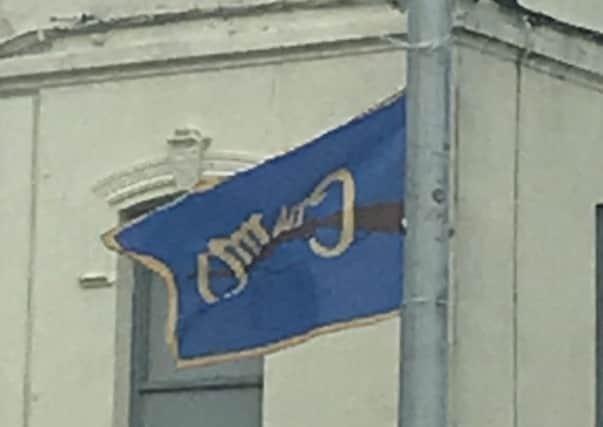 Image sent in by Co Down councillor Alan Lewis of a flag in Newcastle, Co Down, which reads 'Cumann Na Mban', along with an image of a rifle