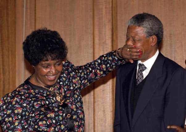 File photo dated 04/07/90 Nelson Mandela being playfully silenced by his wife Winnie Mandela as they leave their closing press conference in Whitehall, London