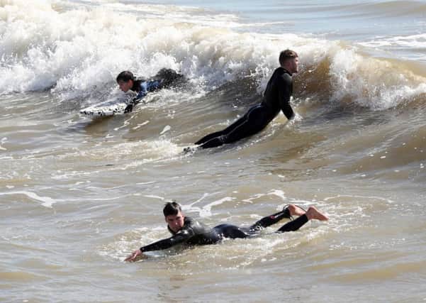 Surfers ride a wave off Boscombe beach in Bournemouth, Dorset on Thursday April 5, 2018. 
Photo: Andrew Matthews/PA Wire