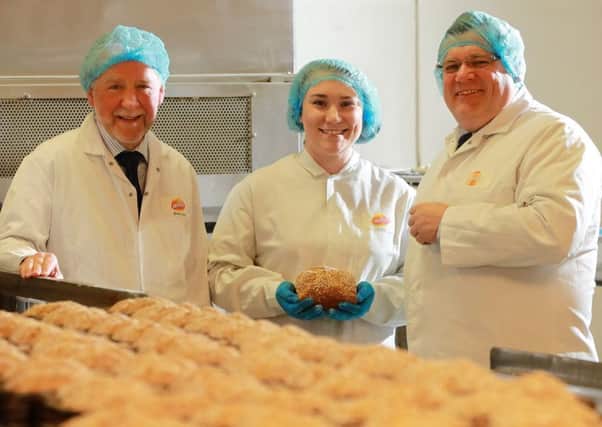 Janine Shilleto, Asda senior buying manager for local and regional foods, pictured during a visit to Irwins Bakery with chairman Brian Irwin, left, and Michael McCallion, buying manager for Asda NI