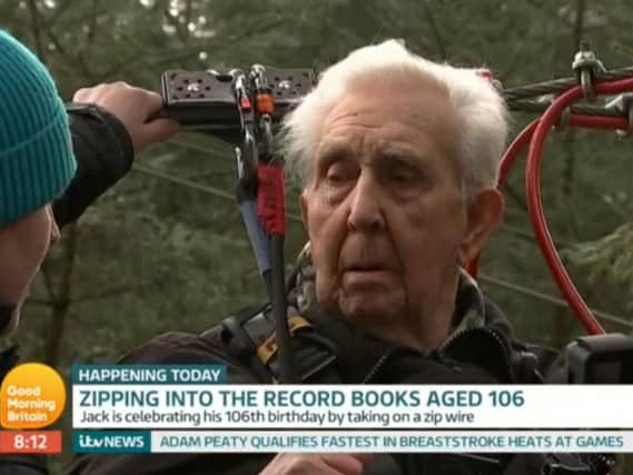 Jack Reynolds riding a zip wire on his 106th birthday. Pic: ITV