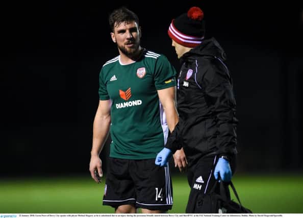 Gavin Peers, pictured with physio Michael Hegarty after sustaining an injury in the pre-season friendly against Sheriff YC.