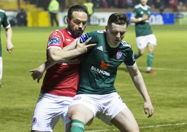 Sligo Rovers substitute, Raffaele Cretaro is held off by Derry City goalscorer, Ronan Hale.