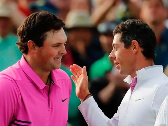 Rory McIlroy (right) congratulates Patrick Reed on winning The Masters