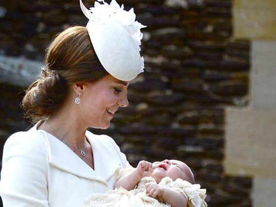 The Duchess of Cambridge carries Princess Charlotte as they arrive at the Church of St Mary Magdalene in Sandringham, Norfolk, for her christening as The Duke and Duchess of Cambridges third child will be baptised as a Christian