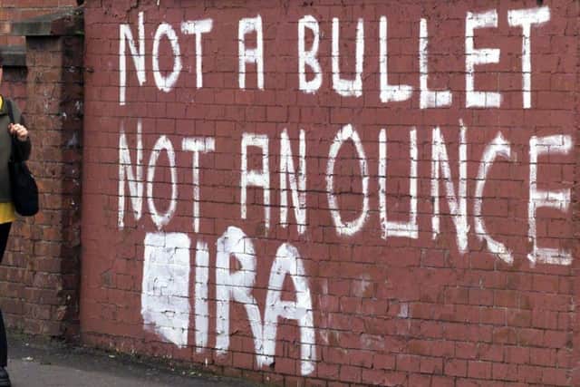 IRA letters painted below existing graffiti in republican west Belfast,opposing decommissioning
