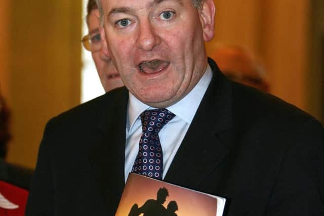 Mark Durkan with a copy of the Belfast Agreement in 1998