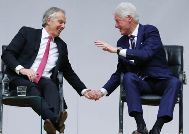 Tony Blair and Bill Clinton share the stage during the Whitla Hall event marking 20 years of the Good Friday Agreement