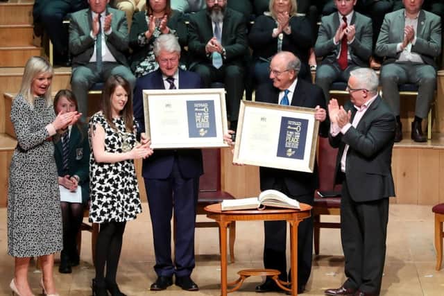 Bill Clinton (left, immediately alongside Belfast Lord Mayor Nuala McAllister) and George Mitchell (immediately alongside SDLP councillor Tim Attwood) with their freedom of the city documents