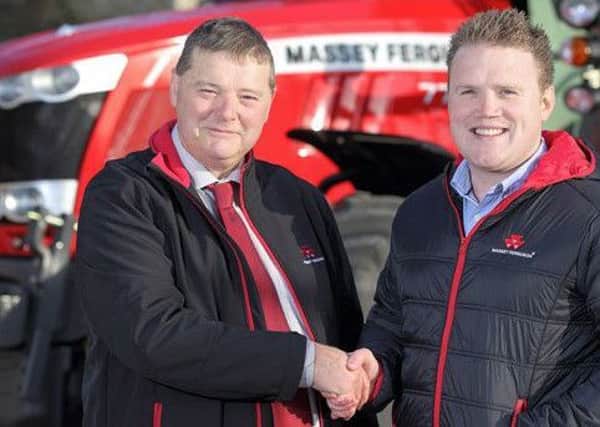 Cecil Troughton, sales manager at William Bell Tractors with James Speers, president, YFCU