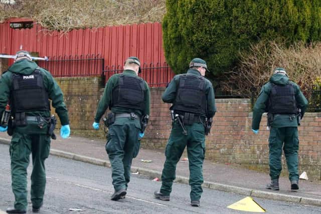 Combing the scene of the shooting in north Belfast