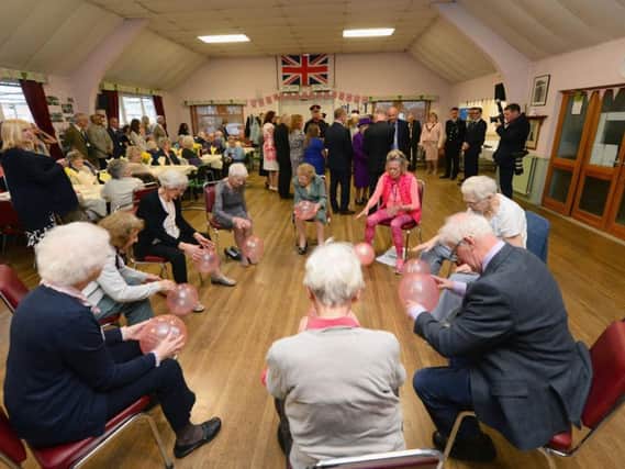 Queen Elizabeth II during a visit to the King George VI Day Centre, Windsor, to mark the 60th anniversary of its opening and the 70th anniversary of the Windsor Old People's Welfare Association.