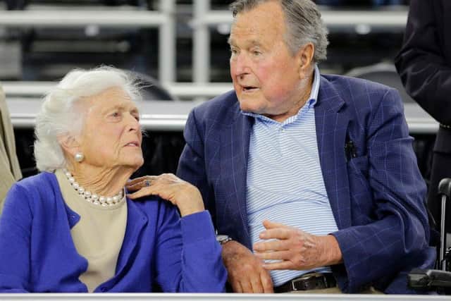 In this March 29, 2015, file photo, former President George H.W. Bush and his wife Barbara Bush, left, speak before a college basketball regional final game between Gonzaga and Duke, in the NCAA basketball tournament in Houston.