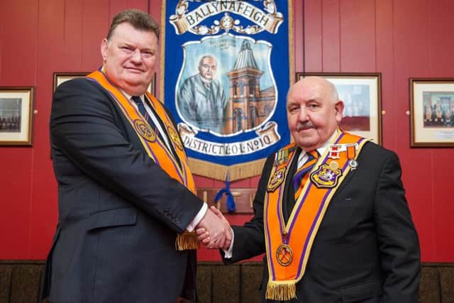 Grand Treasurer of the Grand Orange Lodge of Ireland, Brian Dorrian (left), made a presentation to outgoing Belfast Grand Master George Chittick