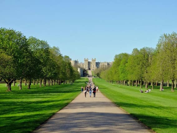 People enjoy the sunshine on the Long Walk at Windsor Castle in Berkshire, as Britain is expecting the hottest day of the year so far