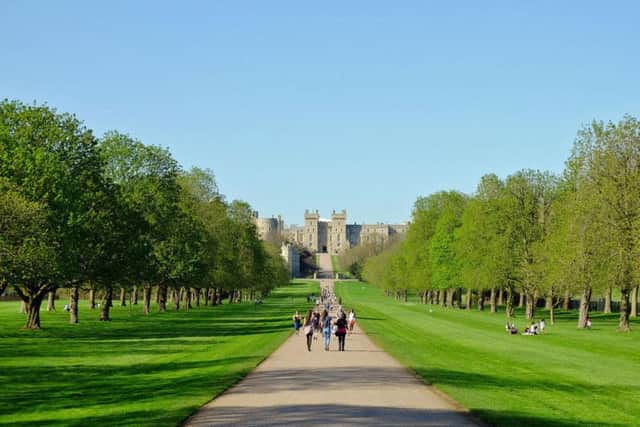 People enjoy the sunshine on the Long Walk at Windsor Castle in Berkshire, as Britain is expecting the hottest day of the year so far