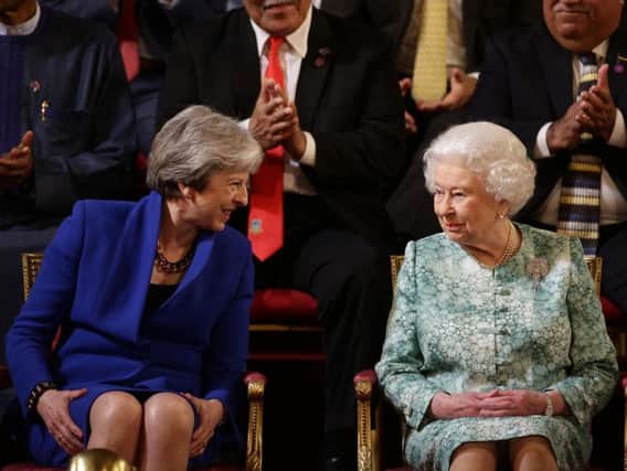 Queen Elizabeth II and Prime Minister Theresa May at the formal opening of the Commonwealth Heads of Government Meeting in the ballroom at Buckingham Palace in London