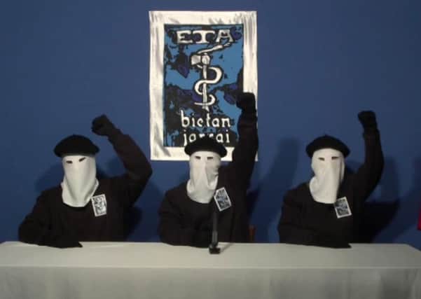 Masked members of the Basque terror group ETA gesture following a news conference. (AP Photo/Gara via APTN)