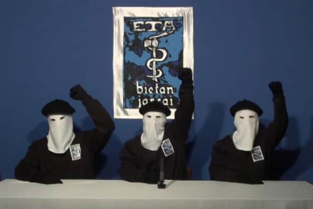 Masked members of ETA gesture following a news conference in 2011. (AP Photo/Gara via APTN)