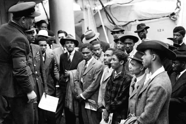 Jamaican immigrants welcomed by RAF officials from the Colonial Office after the ex-troopship  HMT 'Empire Windrush' landed them at Tilbury, England in June 1948.