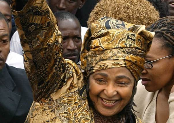 Winnie Madikizela-Mandela, the former wife of Nelson Mandela, raises her fist as she leaves the high court in Pretoria, South Africa, in 2004, after winning her appeal against a four-year jail term for alleged theft and fraud. She endorsed the cruel method of killing known as necklacing